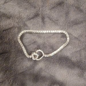 Sterling silver heart clasp cubic zirconia tennis bracelet. 8 inches long.